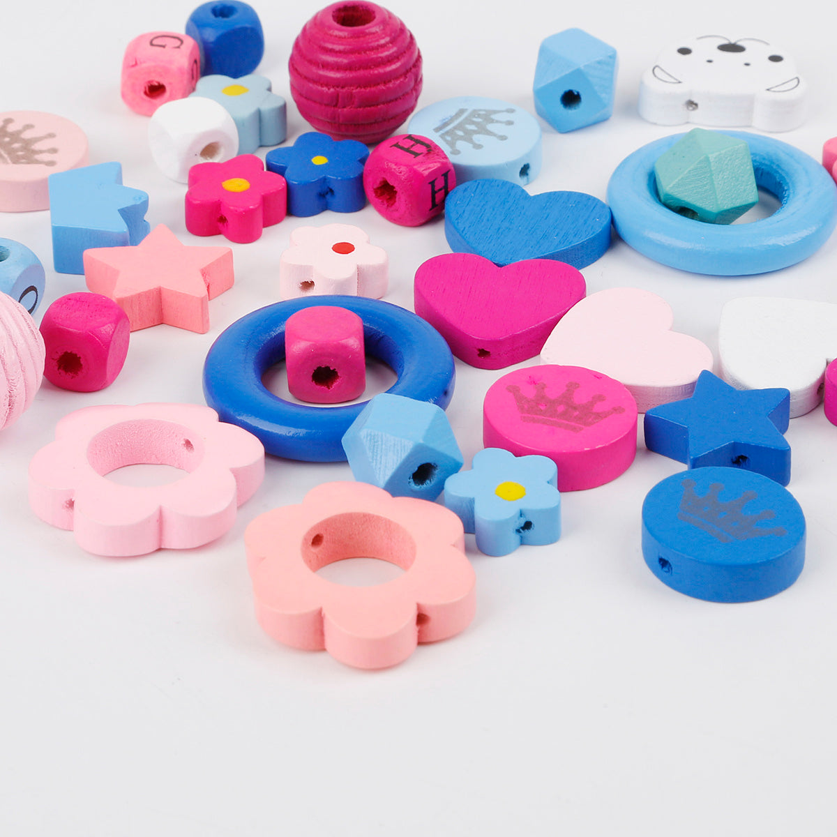 Colorful wooden beaded materials in various shapes like flowers stars hearts for craft projects